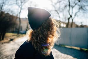 Image of a young woman outside wearing a toque. This image is being used for PolicyWise for Children & Families' news story 